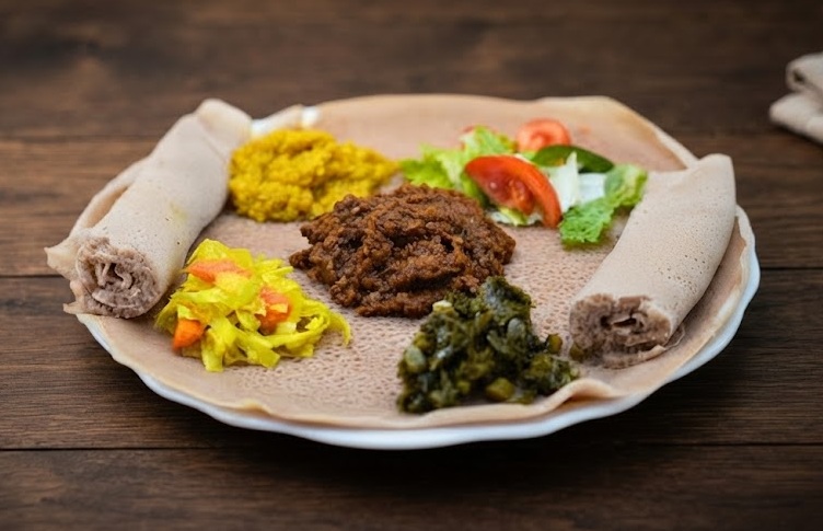 Vegan combo plate with assorted Ethiopian wots on injera at Enat Ethiopian Restaurant London Ontario